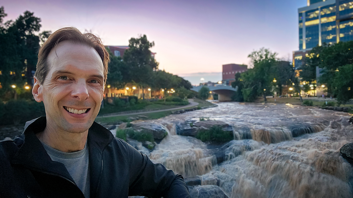 Motivational speaker Larry Weaver on Liberty Bridge overlooking the waterfalls at Falls Park on the Reedy in Greenville, South Carolina