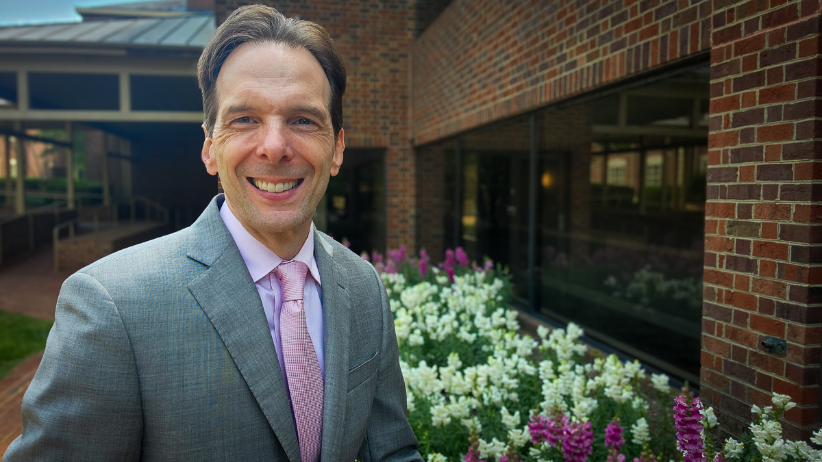 Motivational speaker Larry Weaver enjoying colorful snapdragons in Historic Williamsburg, Virginia