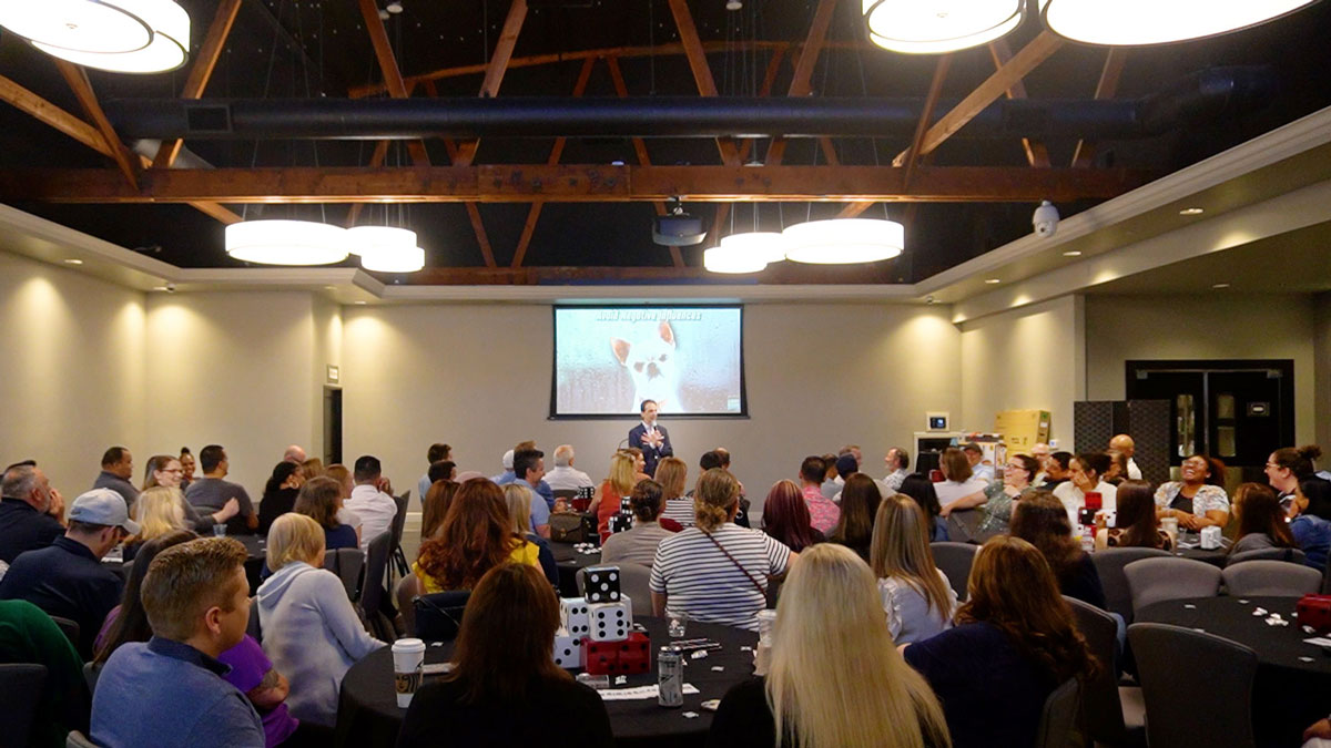 Larry Weaver speaking onstage for a multifamily real estate developer at Roseville Event Center near Sacramento, California.