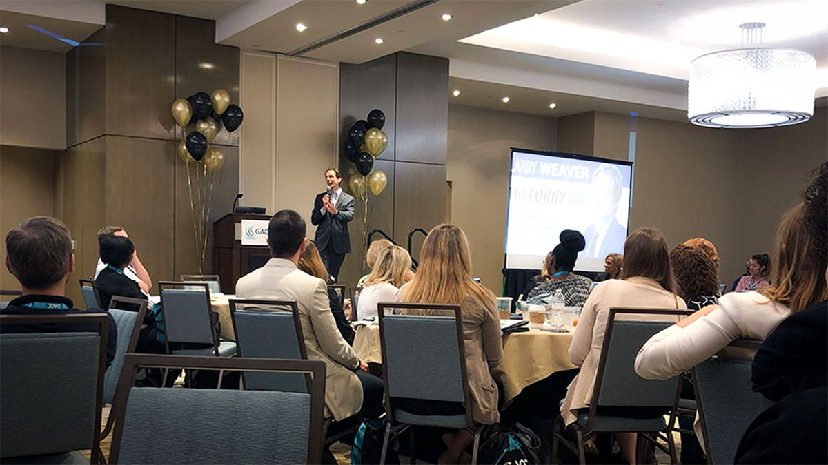 Larry Weaver speaking onstage for college and employer relations professionals during an annual conference at The Westin Jekyll Island in Jekyll Island, Georgia.