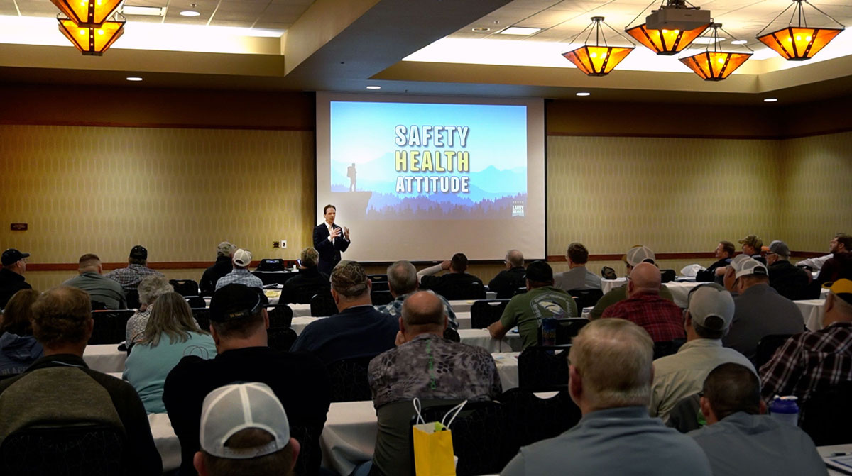 Larry Weaver speaking onstage for county highway superintendents during a short course at The Lodge at Deadwood in Deadwood, South Dakota.
