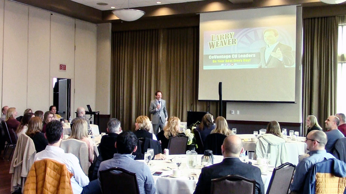 Larry Weaver speaking onstage for credit union business unit leaders at Jefferson Street Inn in Wausau, Wisconsin.