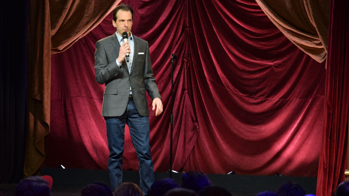 Larry Weaver performing onstage in front of a packed house during his Dry Bar Comedy special taping in Provo, Utah.