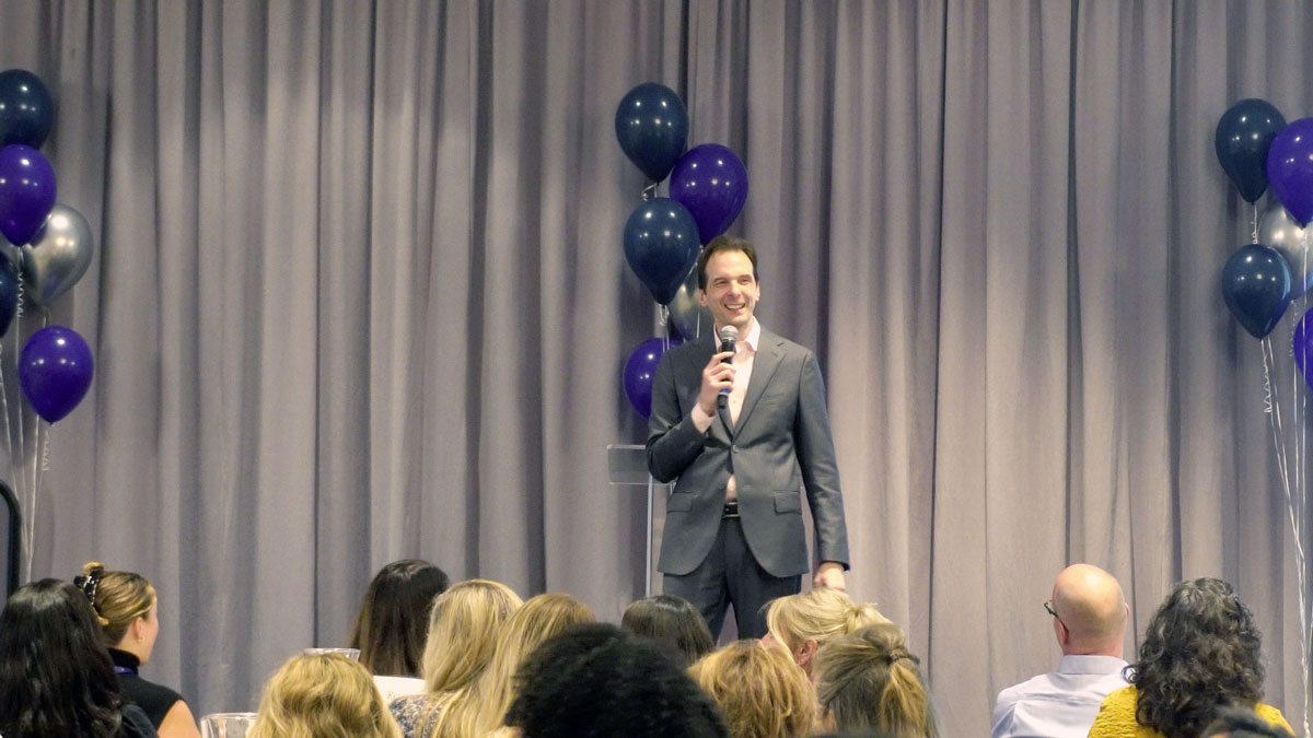 Larry Weaver speaking onstage for family support and public health professionals during a convention at Lexington Griffin Gate Marriott in Lexington, Kentucky.