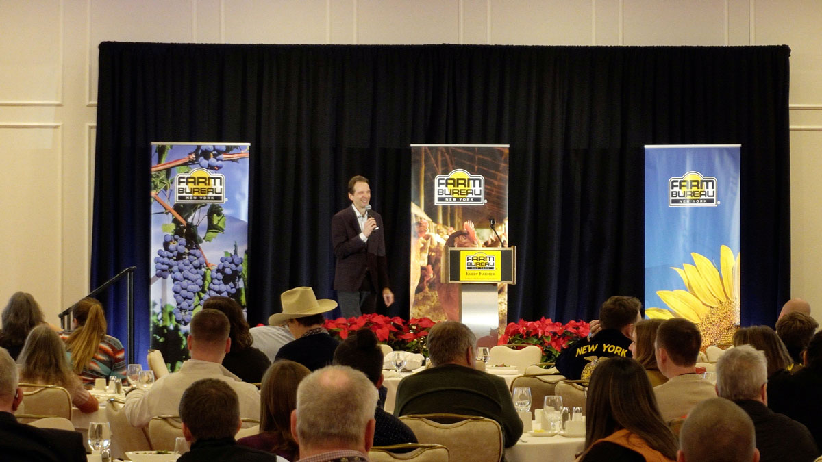 Larry Weaver speaking onstage for agricultural leaders during an annual meeting at Turning Stone Resort Casino in Verona, New York.