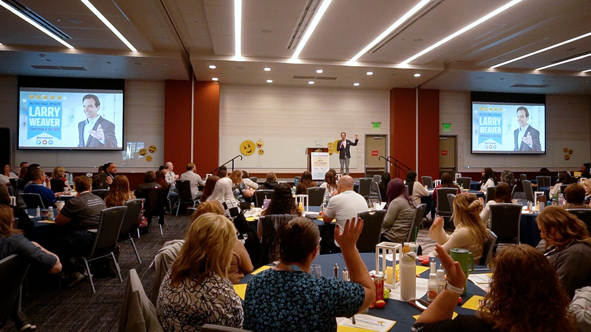 Larry Weaver speaking onstage for housing and energy assistance professionals during fall training at Utah Valley Convention Center in Provo, Utah.