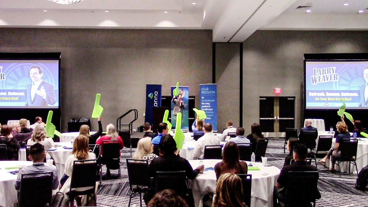 Larry Weaver speaking onstage for a national home healthcare provider at Marriott Phoenix Chandler in Phoenix, Arizona.