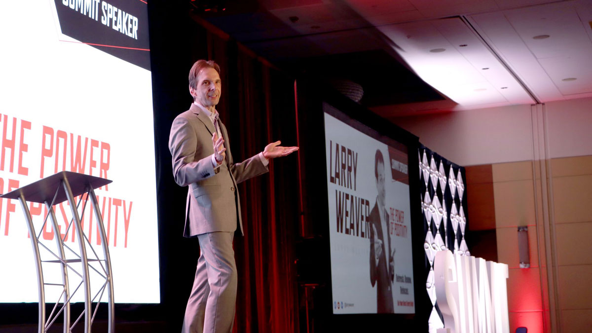 Motivational keynote speaker Larry Weaver presenting The Power of Positivity to transportation professionals at the Renaissance Schaumburg Convention Center near Chicago