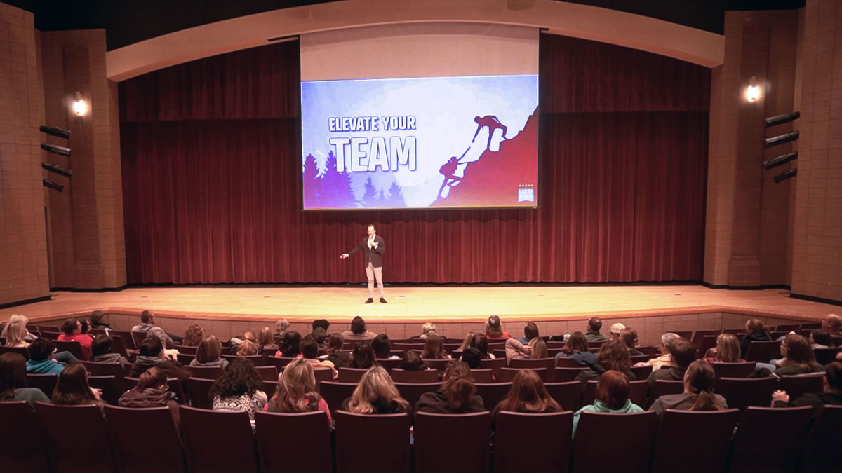 Motivational keynote speaker Larry Weaver presenting to school staff during a mental health and wellness day in Midland, Michigan